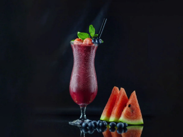 Creative beverage photography by Vishnu Suresh featuring a fresh watermelon mocktail with professional dark lighting